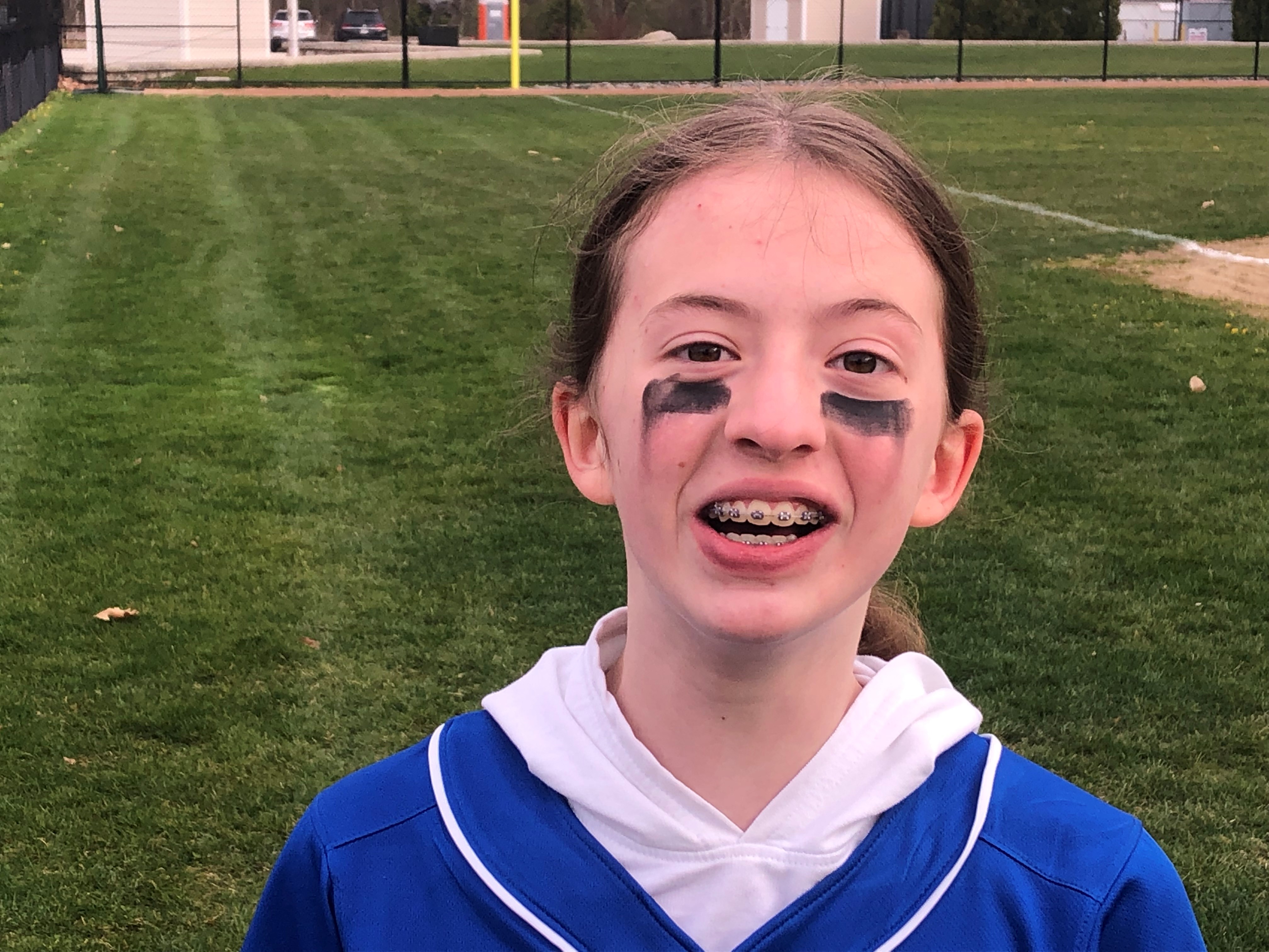 A picture of April Kilkenny in a softball uniform