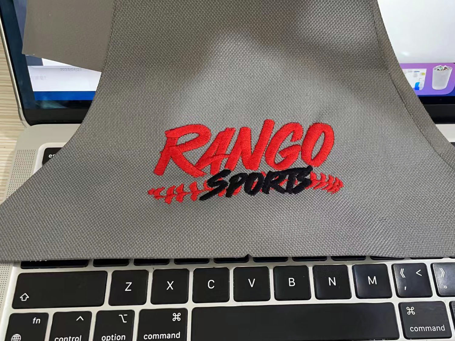 Testing the Rango Sports embroidery logo on a piece of grey scrap cloth