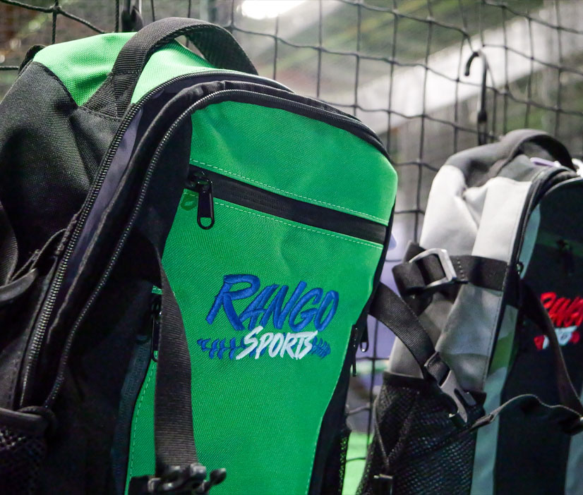 Close-up of a baseball bag with the Rango Sports logo, hanging on a fence