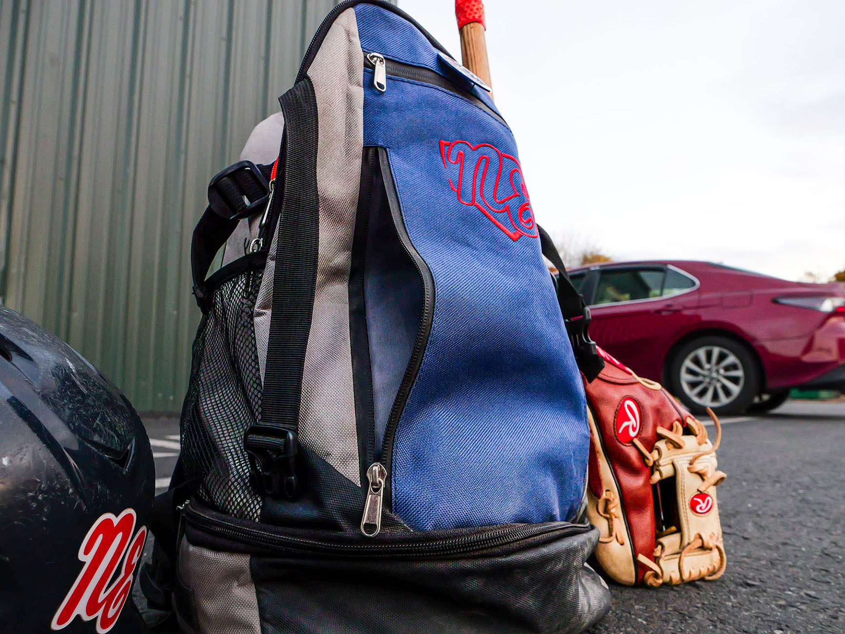 Rango Sports custom baseball bag with bat, glove, and helmet, designed for players to showcase team logos and store gear.