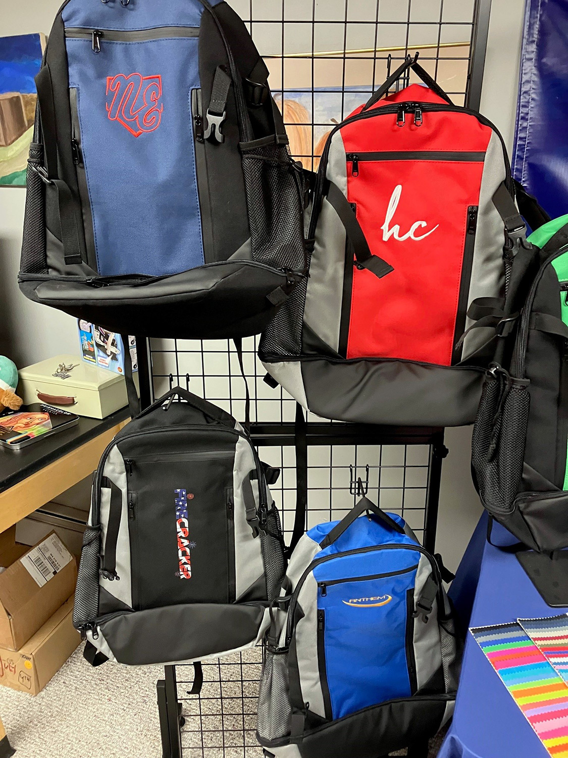 Customized Rango Sports Walrus-pack bags hanging up at a trade event